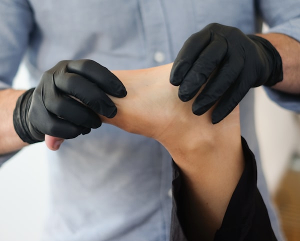 Chiropodist treating patient foot and ankle condition